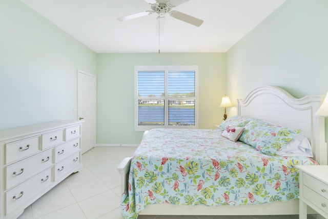 tiled bedroom featuring ceiling fan