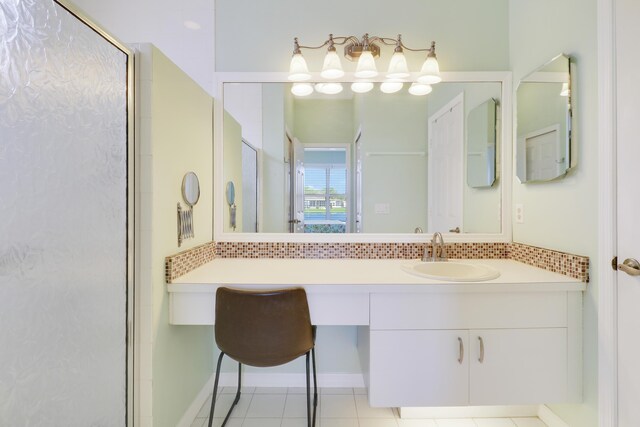 bathroom with tile patterned flooring, vanity, and a shower with door