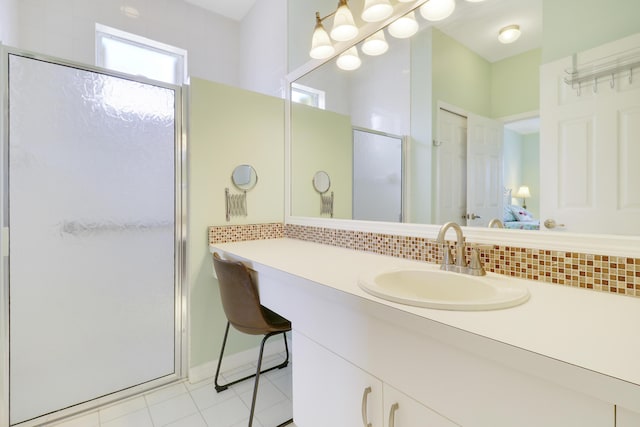 bathroom featuring tasteful backsplash, tile patterned floors, vanity, and walk in shower