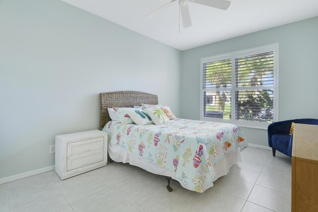 tiled bedroom featuring ceiling fan