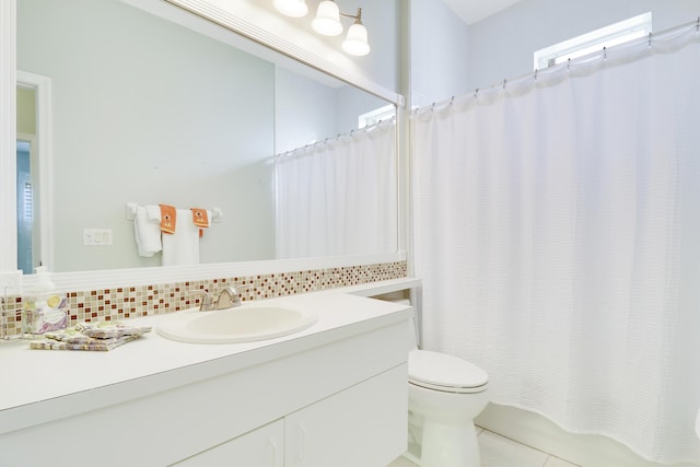 bathroom with tasteful backsplash, tile patterned floors, vanity, and toilet