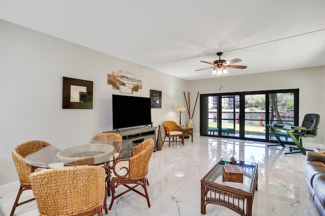 living room featuring ceiling fan and french doors