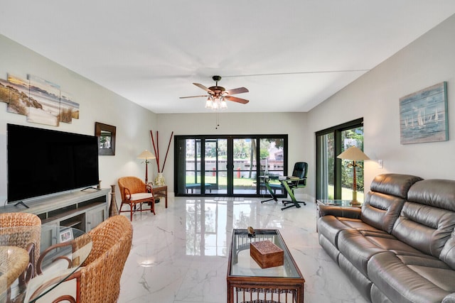 living room featuring ceiling fan and french doors