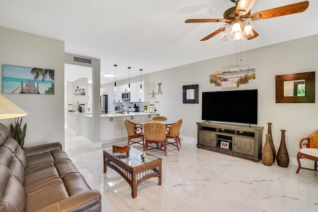 living room with ceiling fan and sink