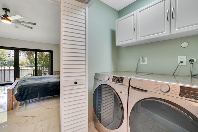 laundry room with washing machine and clothes dryer, ceiling fan, and cabinets