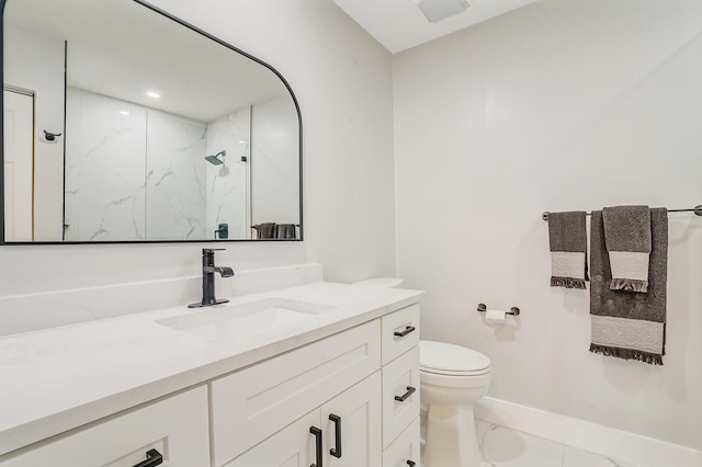 bathroom featuring vanity, toilet, and a shower