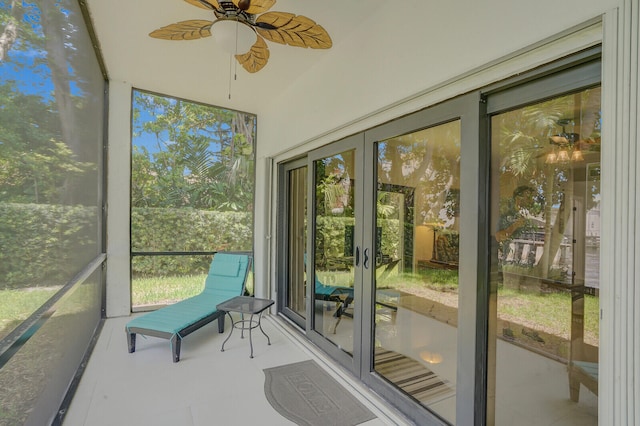 sunroom / solarium featuring ceiling fan and a healthy amount of sunlight