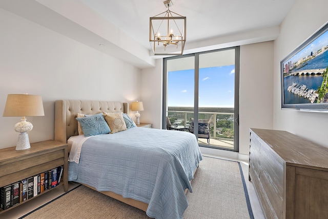 bedroom with a wall of windows, an inviting chandelier, and access to exterior