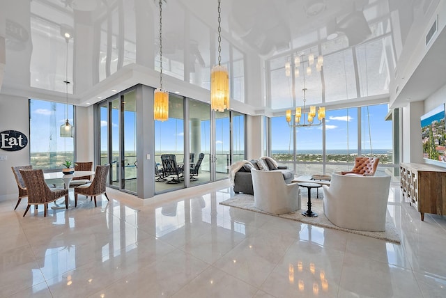 interior space with expansive windows, plenty of natural light, visible vents, and a chandelier