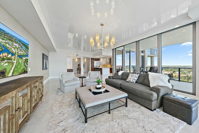 living room featuring baseboards and an inviting chandelier