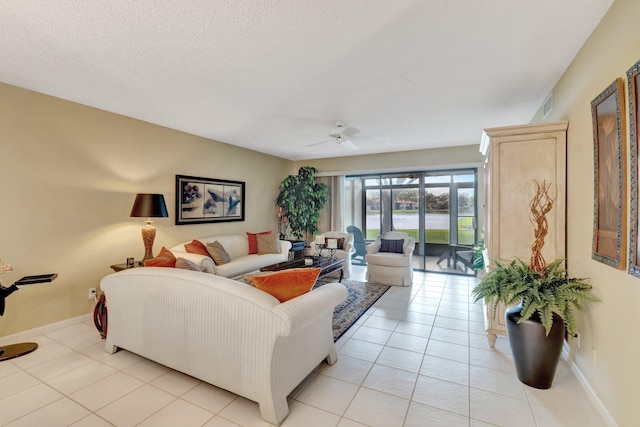 tiled living room featuring ceiling fan and a textured ceiling