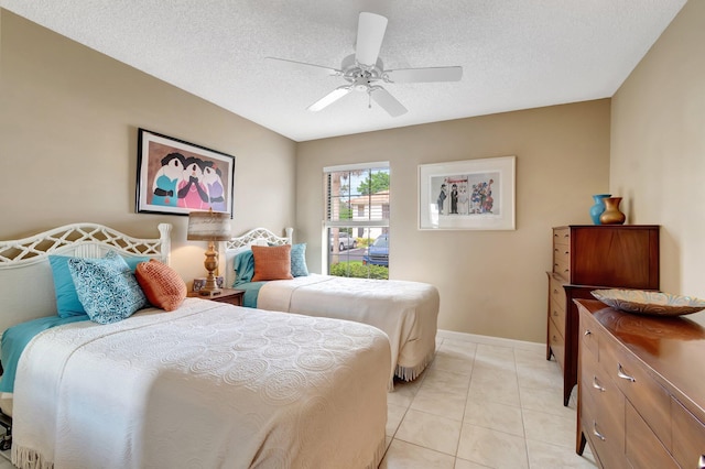 tiled bedroom featuring ceiling fan and a textured ceiling