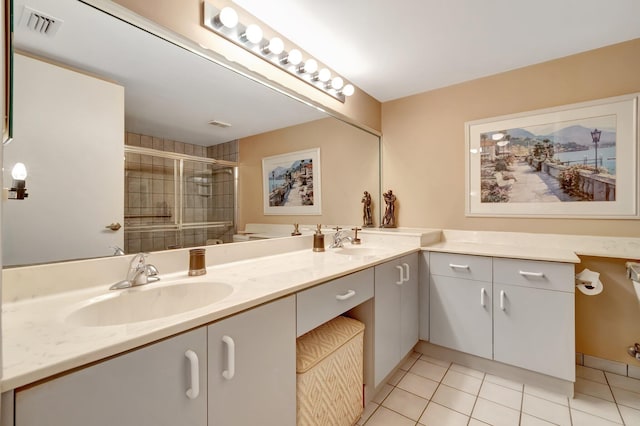 bathroom featuring vanity, tile patterned floors, and a shower with door