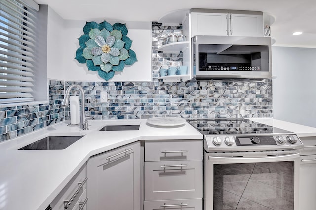 kitchen featuring backsplash, crown molding, tile patterned floors, and appliances with stainless steel finishes