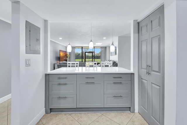 kitchen with gray cabinets, electric panel, light tile patterned floors, and hanging light fixtures