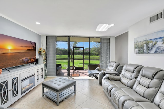 living room featuring light tile patterned flooring and floor to ceiling windows