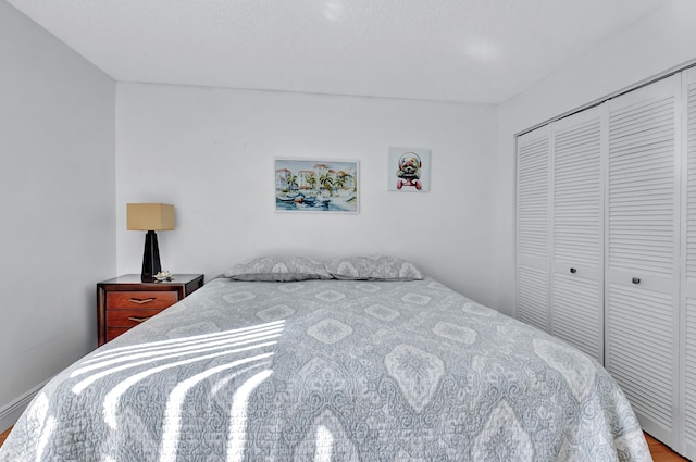 bedroom with wood-type flooring and a closet