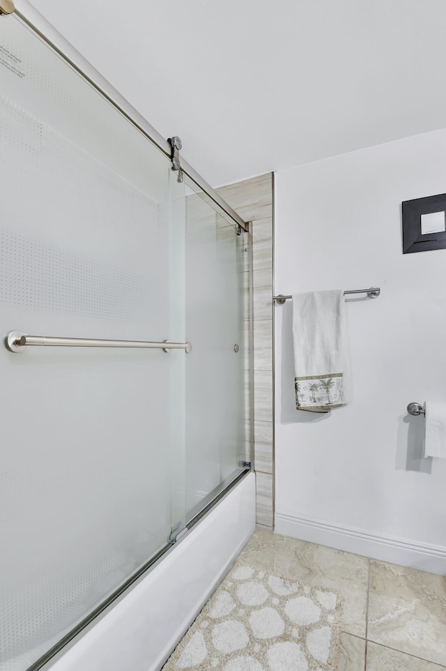 bathroom featuring tile patterned floors and enclosed tub / shower combo