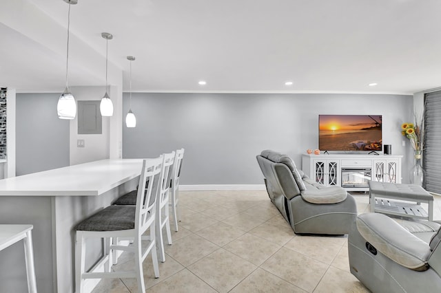 interior space featuring a fireplace, light tile patterned floors, and ornamental molding