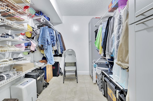 spacious closet with light tile patterned floors