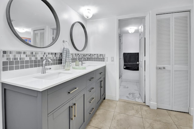 bathroom with decorative backsplash, vanity, and tile patterned flooring