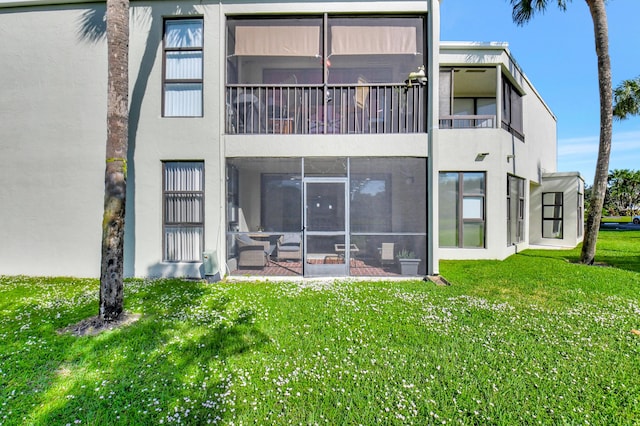 rear view of property featuring a yard