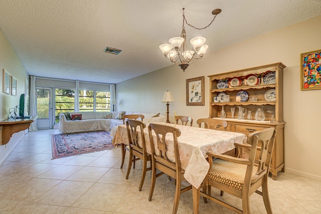 tiled dining area with floor to ceiling windows, a chandelier, and a textured ceiling