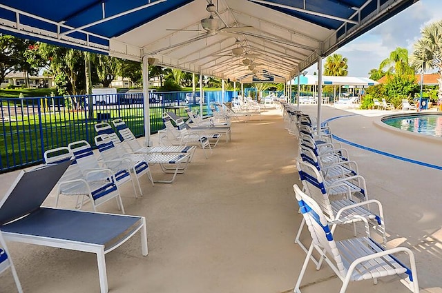 exterior space featuring ceiling fan and a community pool