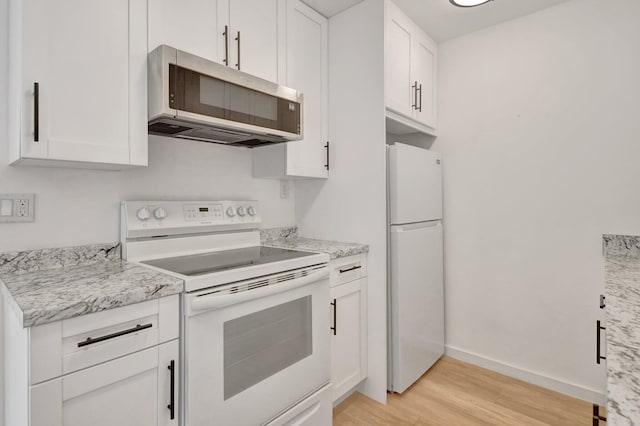 kitchen featuring light stone counters, white cabinetry, light hardwood / wood-style floors, and white appliances