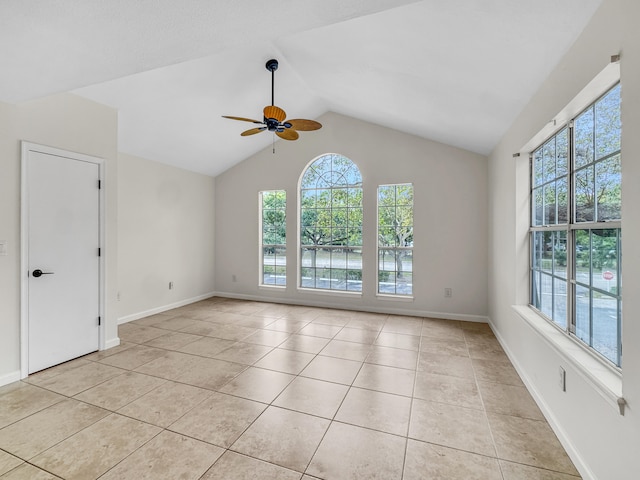 spare room with lofted ceiling, light tile patterned floors, and ceiling fan