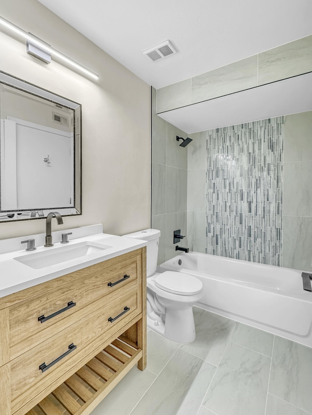 full bathroom with tiled shower / bath, vanity, and toilet