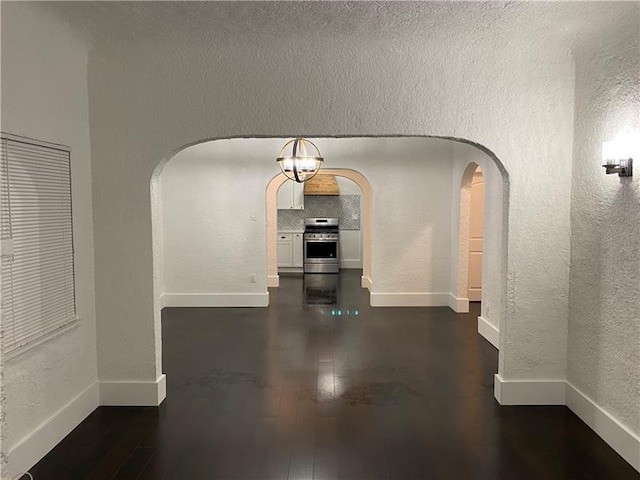 hallway with dark hardwood / wood-style floors