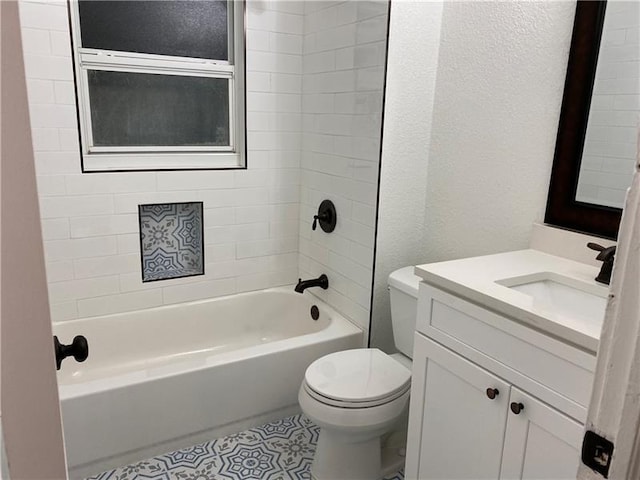 full bathroom featuring vanity, tiled shower / bath combo, and toilet