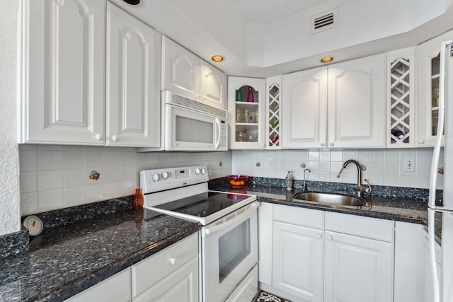 kitchen with white cabinets, white appliances, sink, and tasteful backsplash