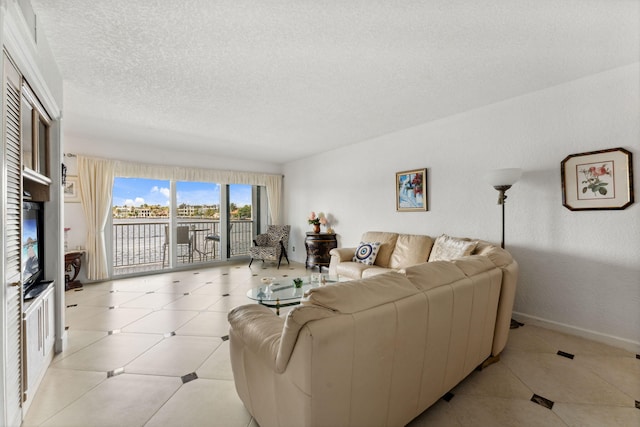 living room featuring light tile patterned floors and a textured ceiling