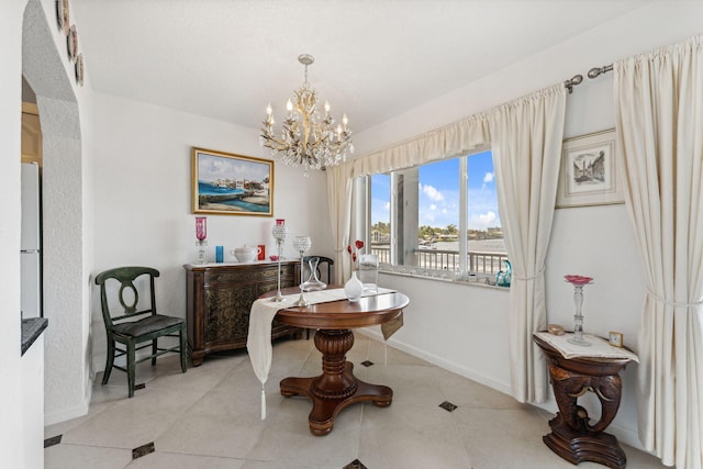 dining space with light tile patterned floors and a notable chandelier