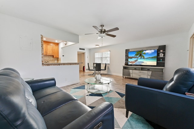 living room featuring light hardwood / wood-style floors and ceiling fan