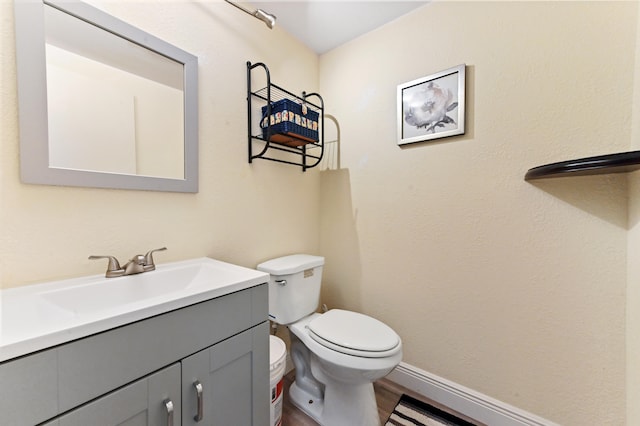 bathroom featuring vanity, toilet, and wood-type flooring