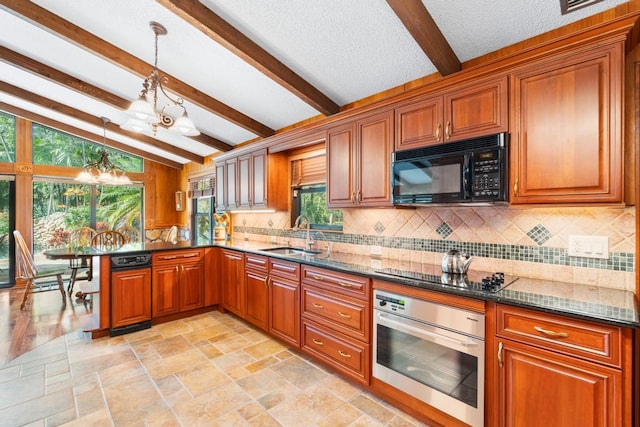 5405 Duckweed Rd, Wellington, FL 33449 - kitchen with pendant lighting, dark stone counters, black appliances, sink, and a chandelier