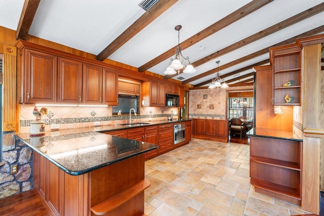 5405 Duckweed Rd, Wellington, FL 33449 - kitchen featuring sink, kitchen peninsula, oven, dark stone counters, and decorative light fixtures