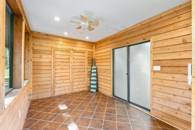 5405 Duckweed Rd, Wellington, FL 33449 - spare room with ceiling fan, wood walls, and dark tile patterned floors