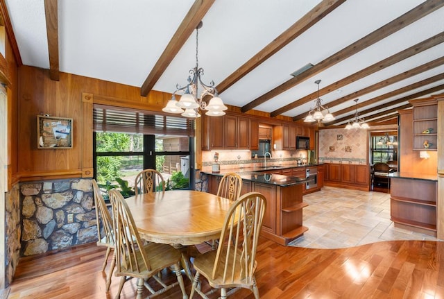 5405 Duckweed Rd, Wellington, FL 33449 - dining room with lofted ceiling with beams, sink, a chandelier, and light hardwood / wood-style floors