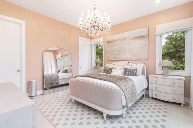 bedroom with an inviting chandelier and multiple windows