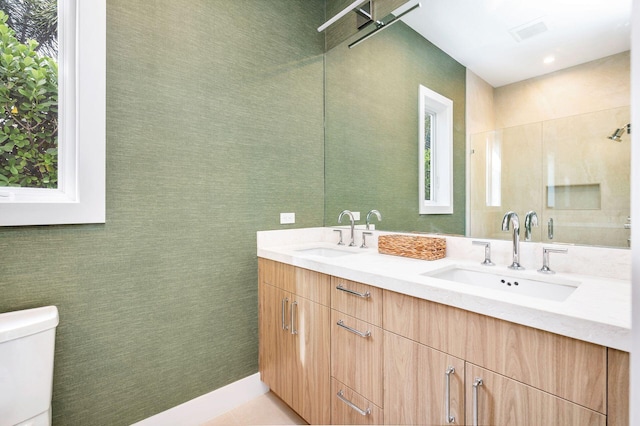 bathroom featuring tile patterned flooring, vanity, and toilet