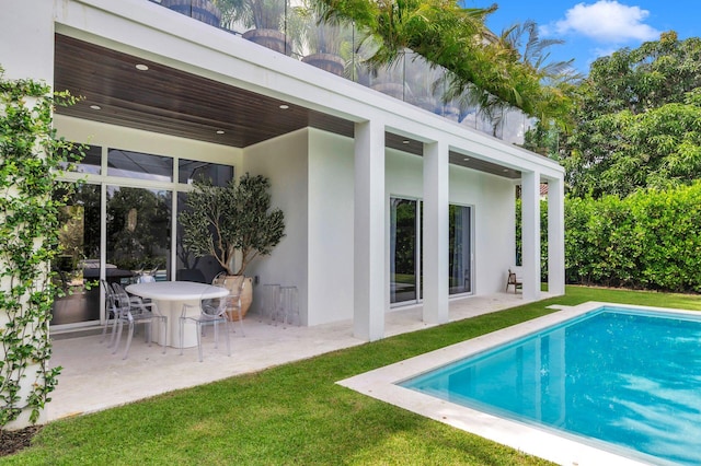 rear view of property with a patio area and a lawn