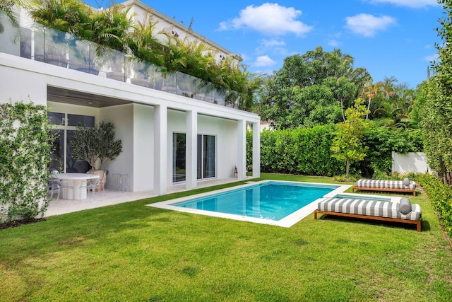 view of swimming pool featuring a yard and a patio