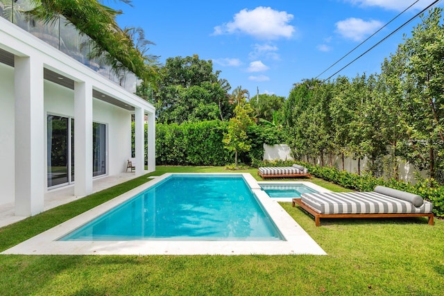 view of swimming pool featuring a lawn