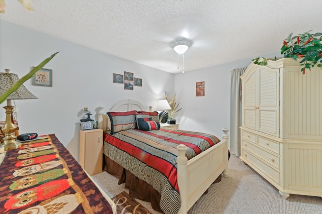 carpeted bedroom with ceiling fan and a textured ceiling