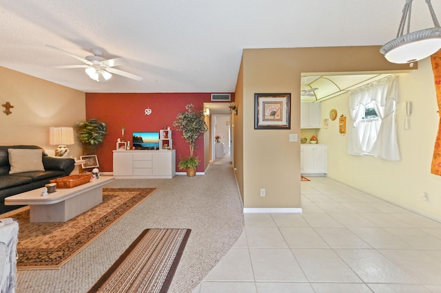 tiled living room featuring ceiling fan and vaulted ceiling