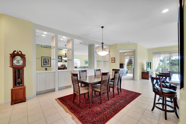 dining area featuring light tile patterned floors and ceiling fan